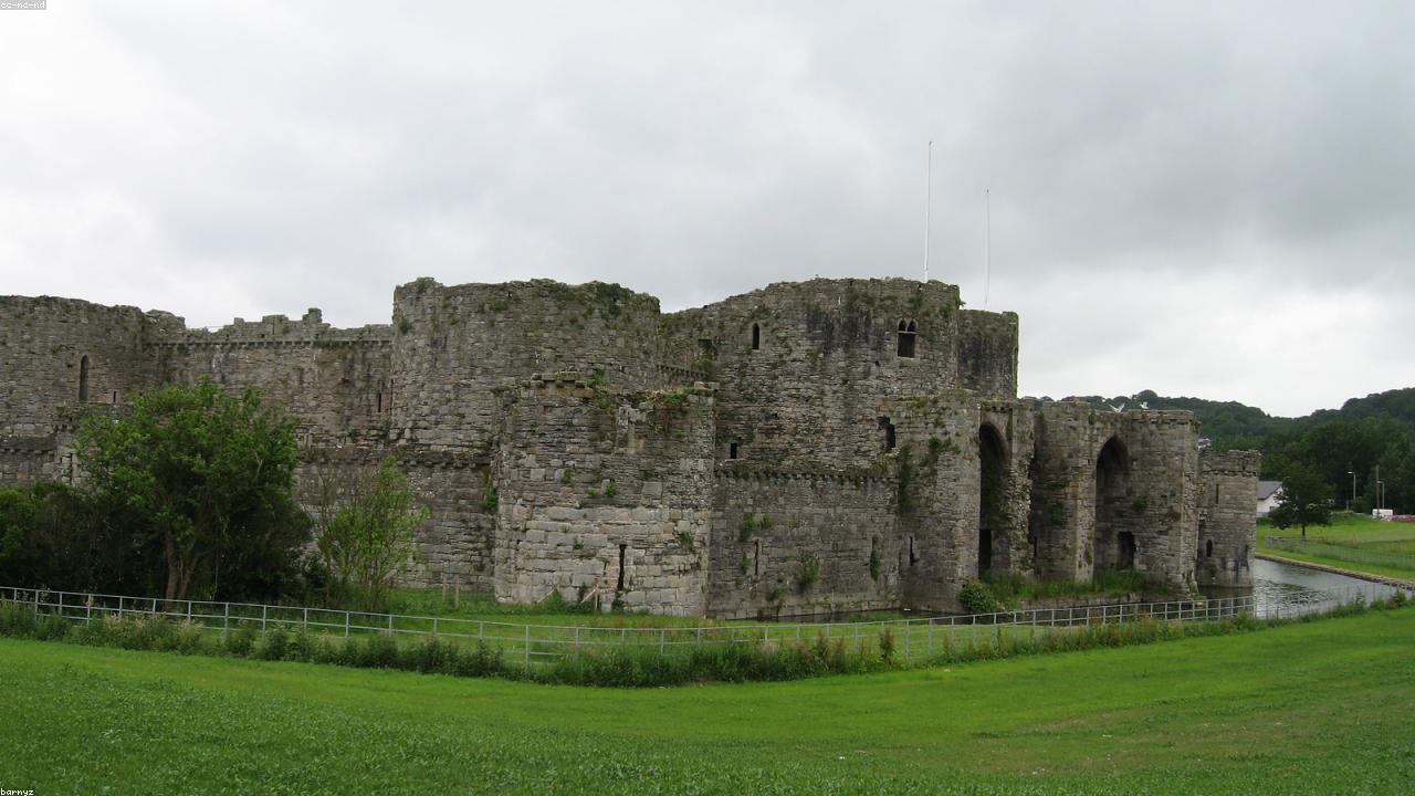 Beaumaris Castle moat and concentric walls reflected in still water