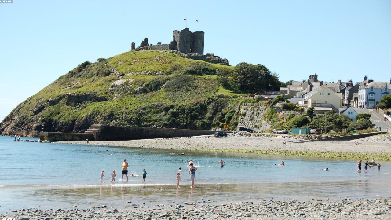 Criccieth east beach with castle headland above and Cardigan Bay beyond