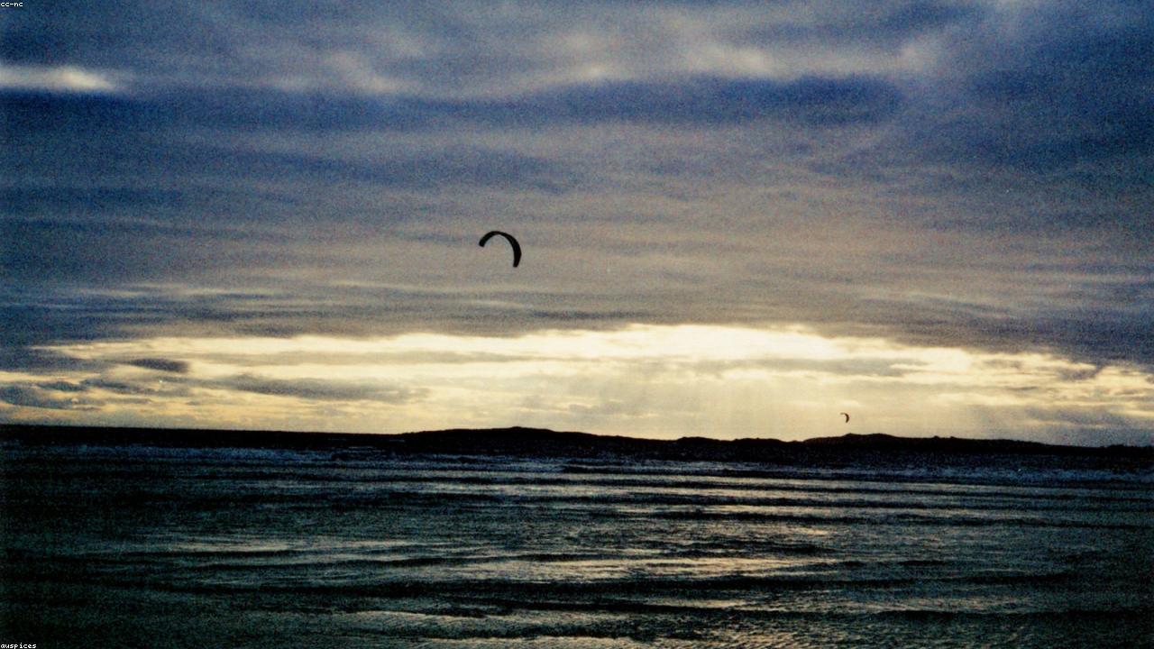Kitesurfer launching off the beach at Rhosneigr on Anglesey's west coast