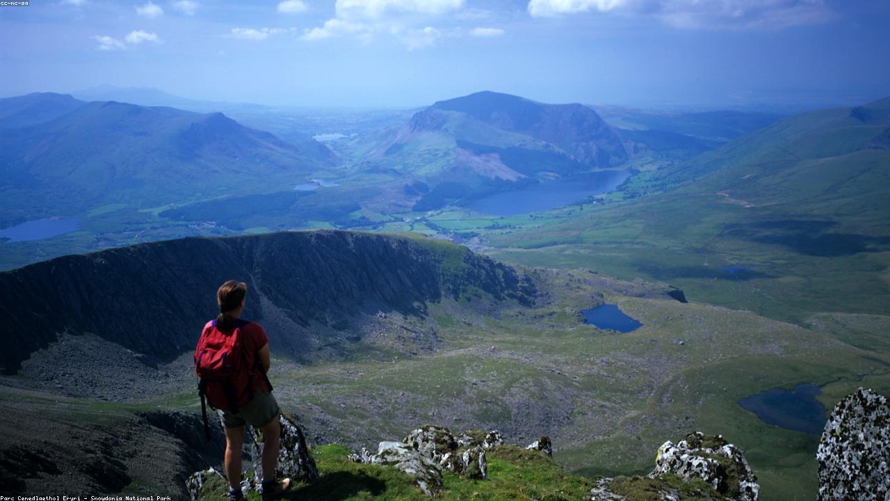 Nantlle Ridge stretching into the distance with Snowdon beyond and Cardigan Bay glittering