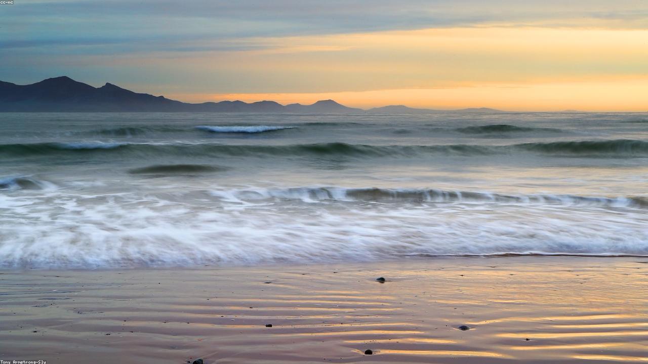 Newborough Beach wide dune sands with Llanddwyn Island and Snowdonia beyond