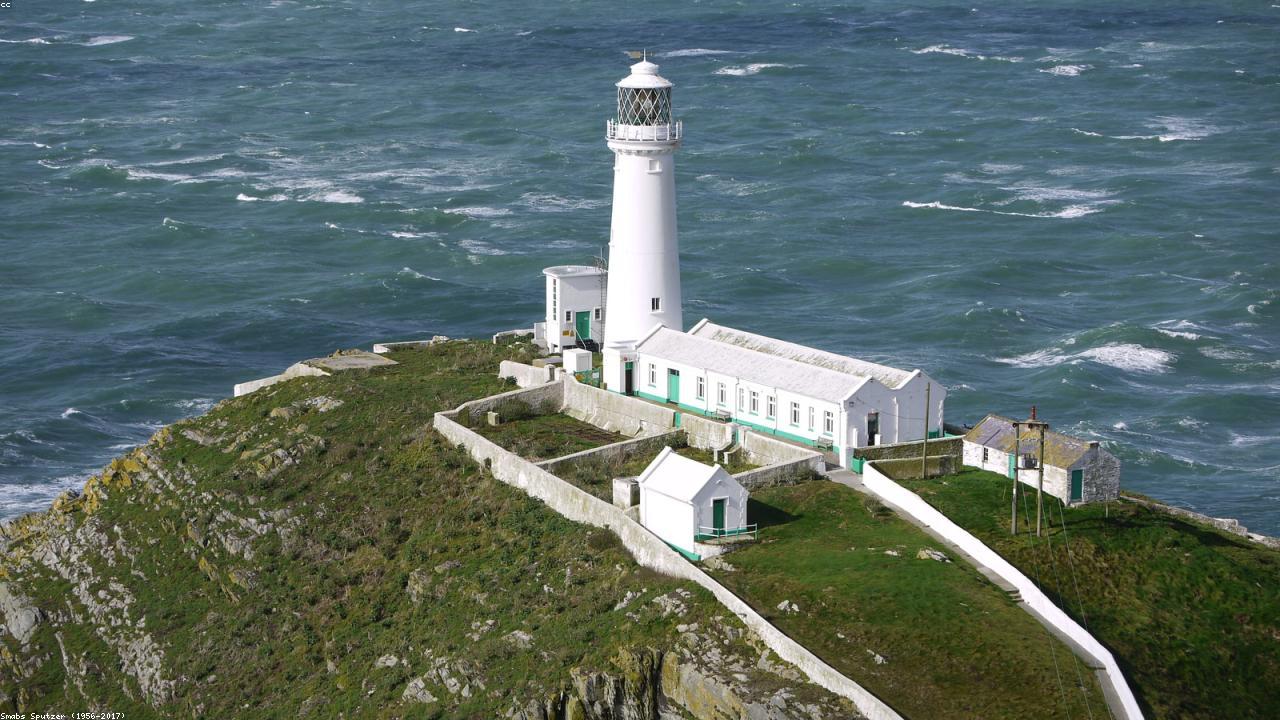 South Stack Lighthouse on sea stack off Holy Island Anglesey with cliffs and seabirds