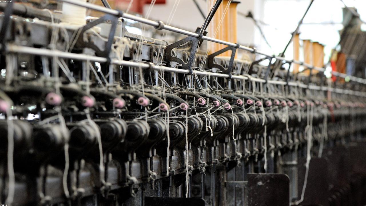Trefriw Woollen Mills weaving shed with looms and colourful Welsh tapestry fabrics on the Afon Crafnant