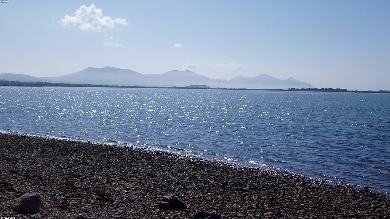 Yr Eifl three peaks rising above the Llŷn Peninsula coast with Cardigan Bay beyond