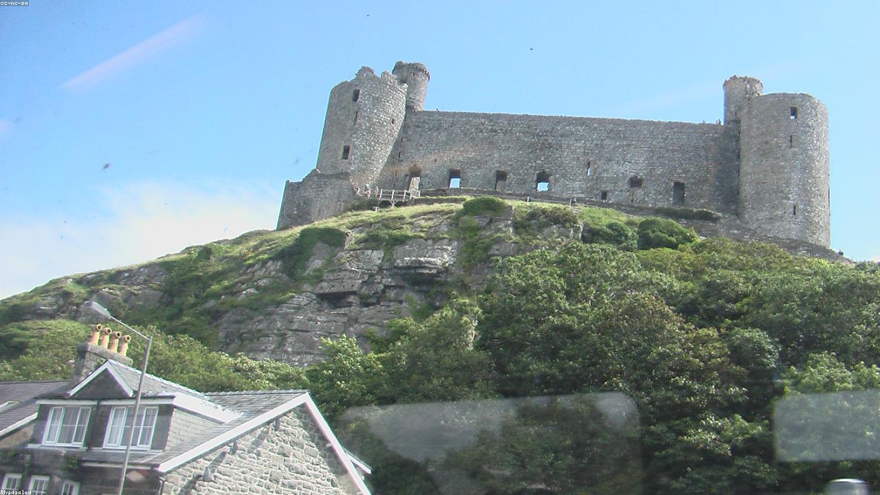 Harlech Castle on its cliff above Tremadog Bay with Snowdonia behind, Gwynedd