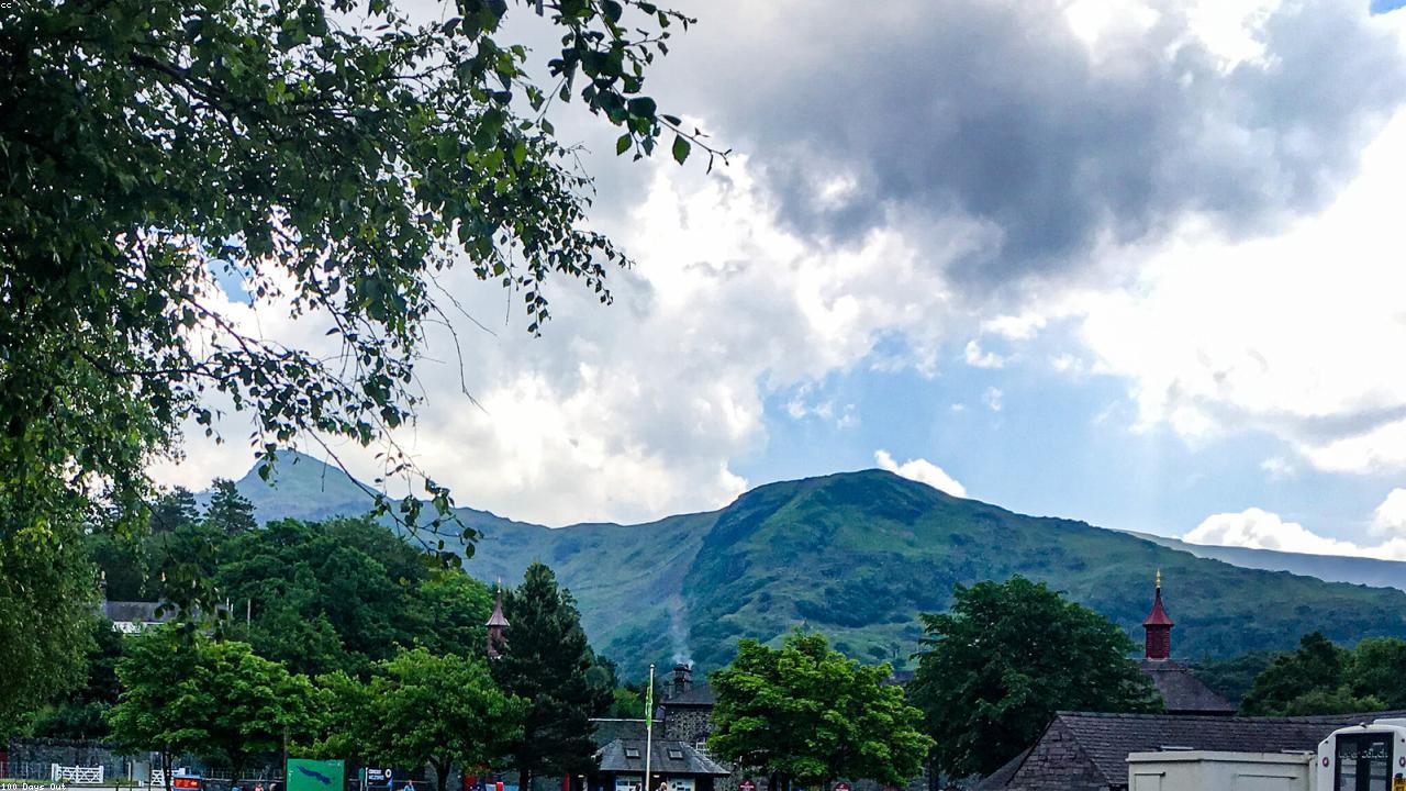 Llanberis village beside Llyn Padarn with Snowdon above in Snowdonia National Park